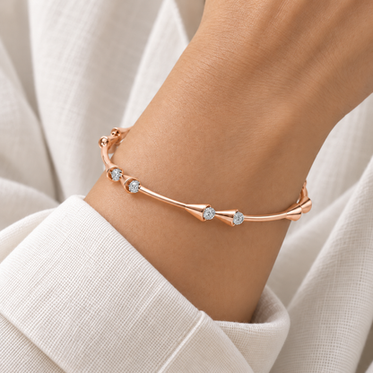 Drop-lays Rose Gold Bangle worn on wrist