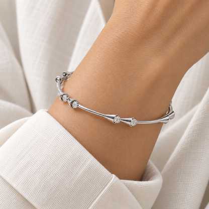 Drop-lays White Gold Bangle worn on wrist