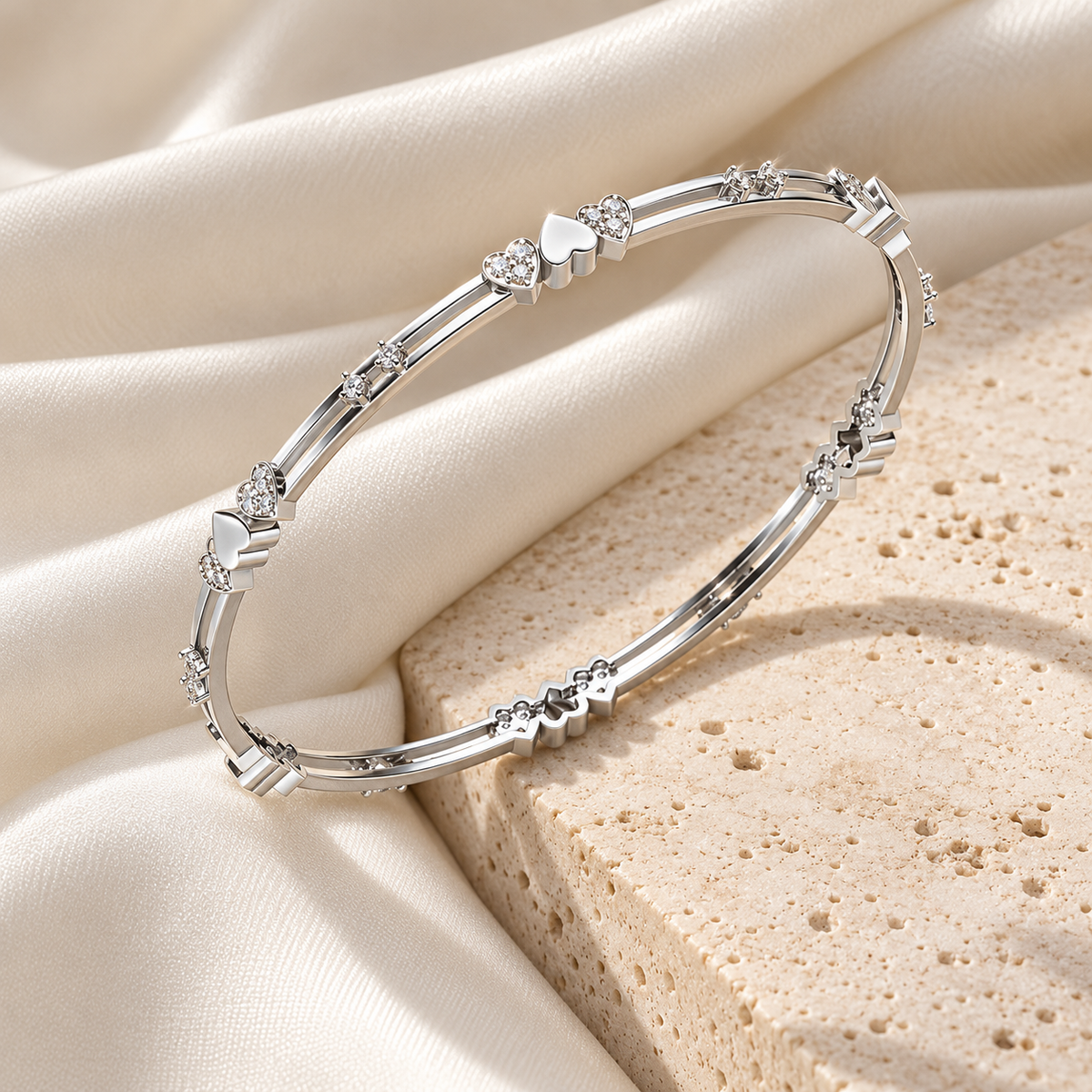 Heartly Silver Bangles in White Gold on an ivory silk and stone editorial setting