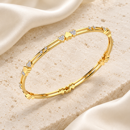 Heartly Silver Bangles in Yellow Gold on an ivory silk and stone editorial setting