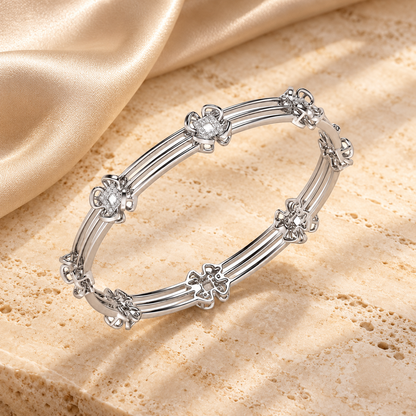 Taar Phool Silver Bangles in white gold on travertine and champagne silk